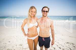 Portrait of young couple standing on the beach