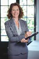 Smiling businesswoman taking notes