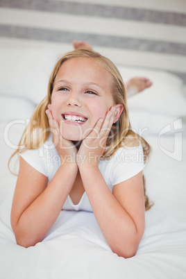 Smiling girl relaxing on bed