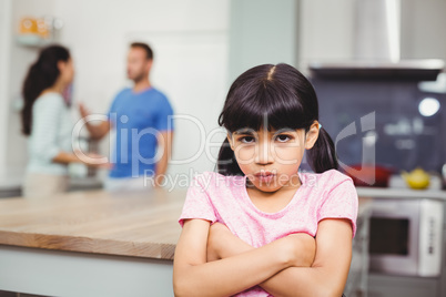 Portrait of angry daughter with arms crossed