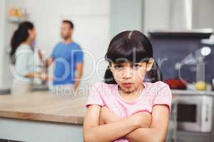 Portrait of angry daughter with arms crossed