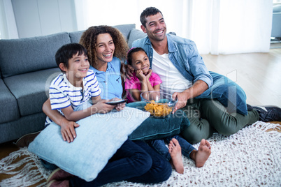 Family watching american football match on television