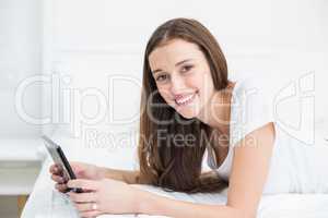Portrait of smiling woman holding digital tablet