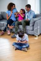 Upset boy sitting on floor with arms crossed