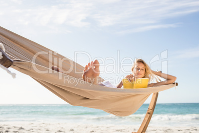 Woman reading book in hammock