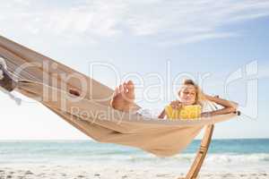 Woman reading book in hammock