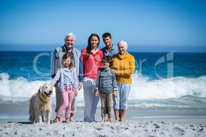 Happy family with their dog at the beach