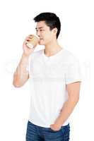 Young man drinking coffee from a disposable cup