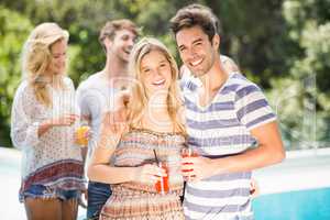 Young couple smiling and having juice together