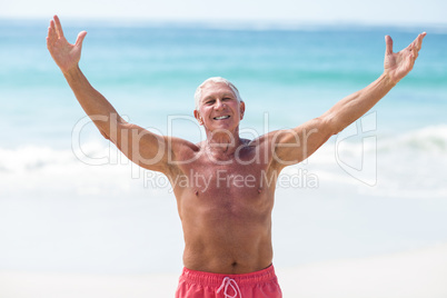 Handsome mature man outstretching his arms