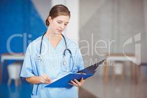 Beautiful female doctor holding clipboard