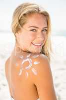 Smiling woman with sunscreen on her skin