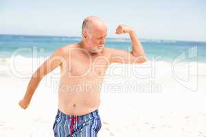 Senior man posing with his muscles