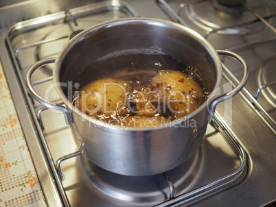 Boiling potato in saucepan