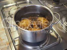 Boiling potato in saucepan