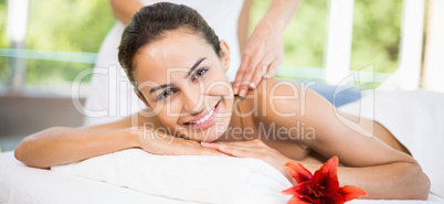 Portrait of young woman receiving massage