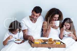 Family having breakfast in bed