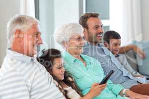 Happy family sitting on sofa