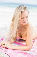 Pretty woman in bikini lying on the beach