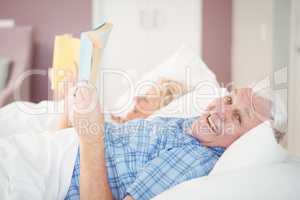 Portrait of senior man holding book