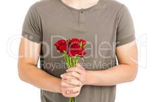 Mid section of man holding bunch of red roses