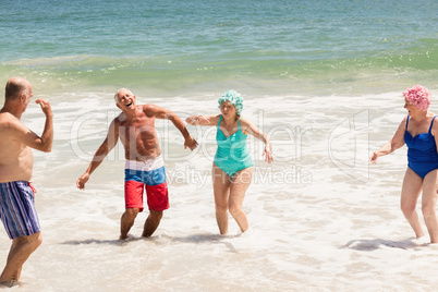 Senior friends playing in water