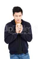 Young man holding disposable coffee cup