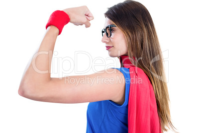 Woman in superhero costume while flexing muscles
