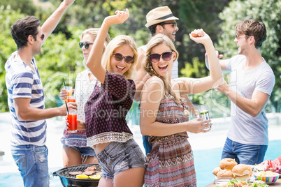 Group of friends dancing at outdoors barbecue party