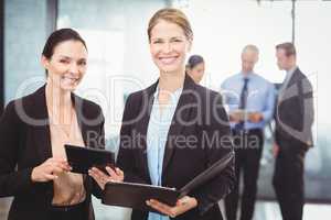 Portrait of businesswomen holding digital tablet and file