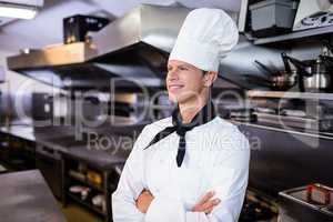 Happy male chef standing with arms crossed