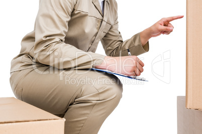 Delivery man counting cardboard boxes