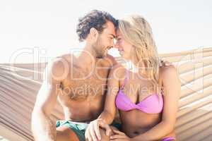 Smiling couple sitting in hammock