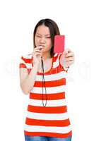 Young woman whistling and showing red card