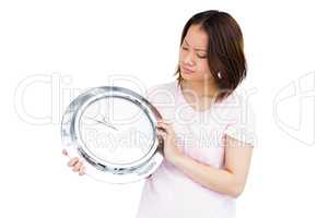 Young woman holding stainless steel clock