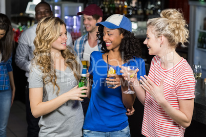 Happy friends drinking cocktails