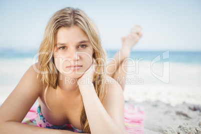 Portrait of woman in bikini lying on the beach