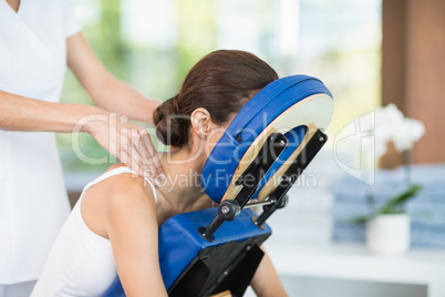Young woman receiving back massage