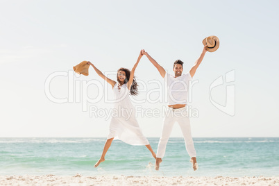 Smiling couple jumping together