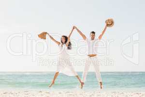 Smiling couple jumping together