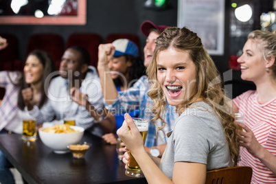 Happy friends watching sport