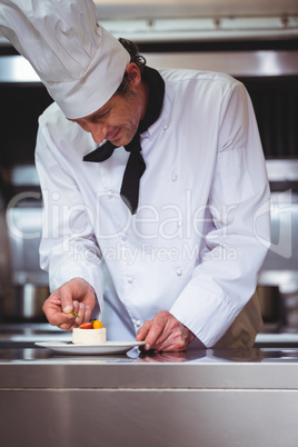 Chef putting finishing touch on dessert