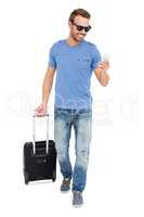 Young man with trolley bag and mobile phone