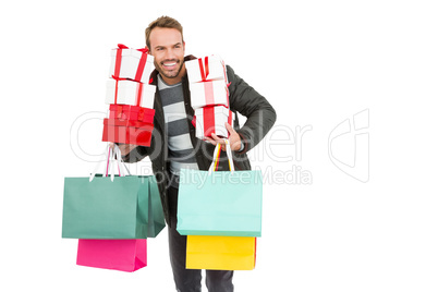 Young man holding gifts and shopping bags