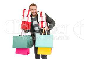 Young man holding gifts and shopping bags