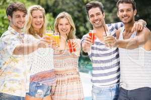 Group of friends showing their glass of juice