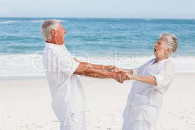 Senior couple dancing on the beach Senior couple dancing on the beach