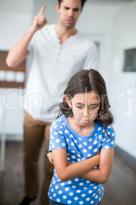 Sad daughter with arms crossed