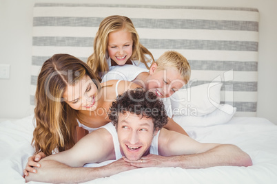 Happy family enjoying on bed at home