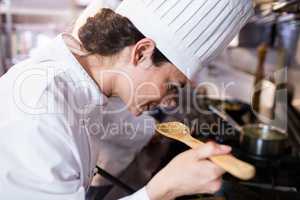 Chef smelling food in the kitchen